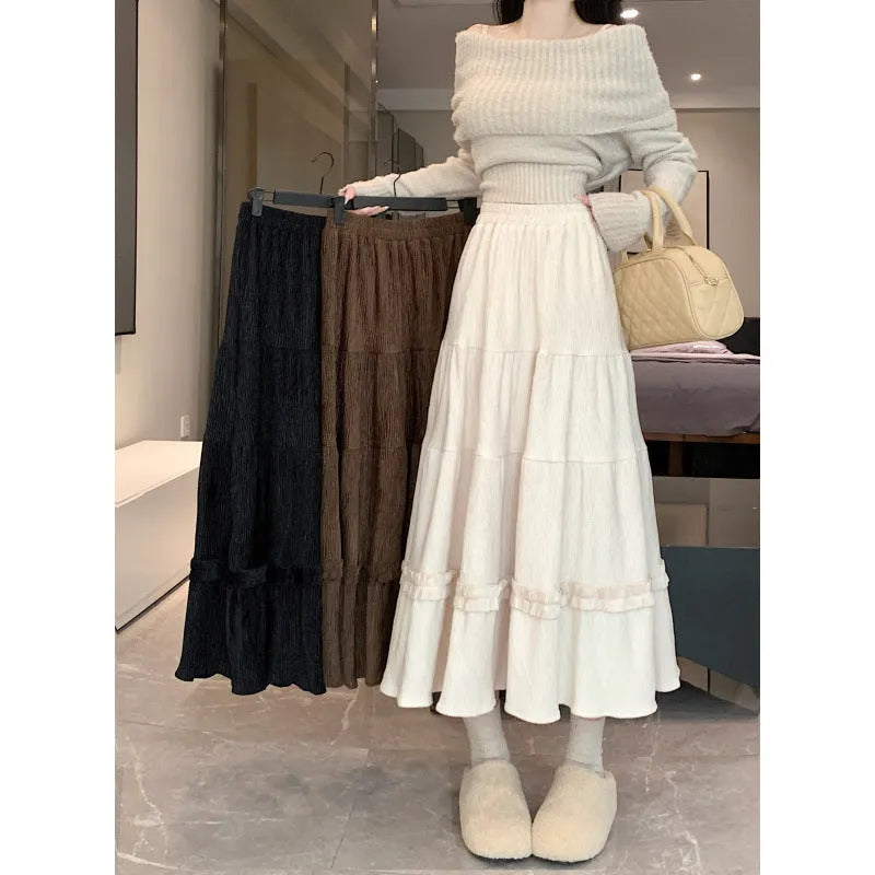 Korean-style beige corduroy A-line midi skirt with an elasticated waistband on a hanger.