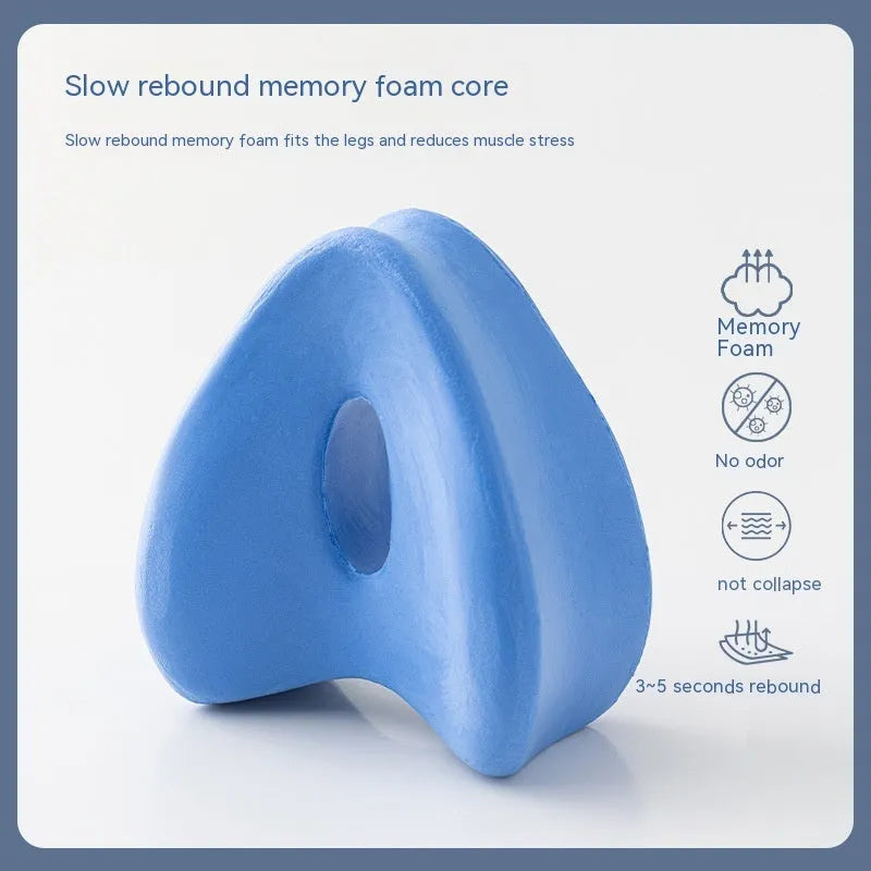 Love heart-shaped dark blue jacquard memory foam leg pillow for adults on a bed.