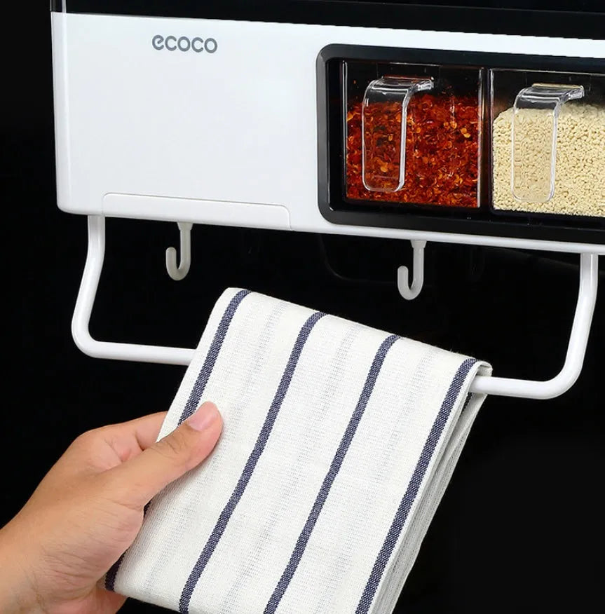 White plastic wall-mounted kitchen storage box with compartments for tools and seasonings