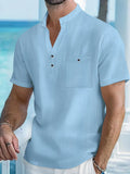 Man wearing a light-coloured linen stand collar t-shirt with short sleeves in a loose fit