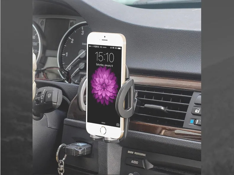 Black universal car mobile phone holder mounted on air conditioning outlet with smartphone secured