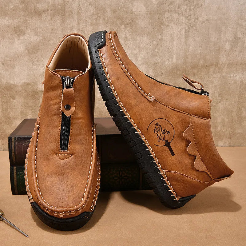 Men's black slip-on leather loafers with a round toe and rubber sole on a plain background.