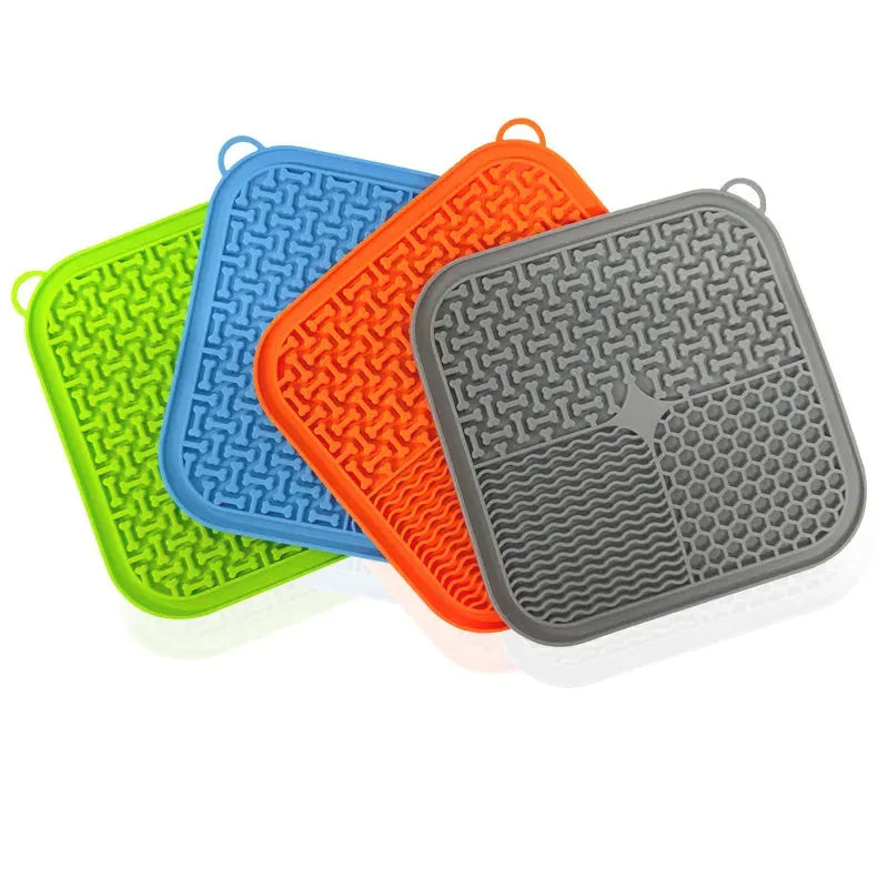 Blue silicone dog licking mat with suction cups on a smooth surface
