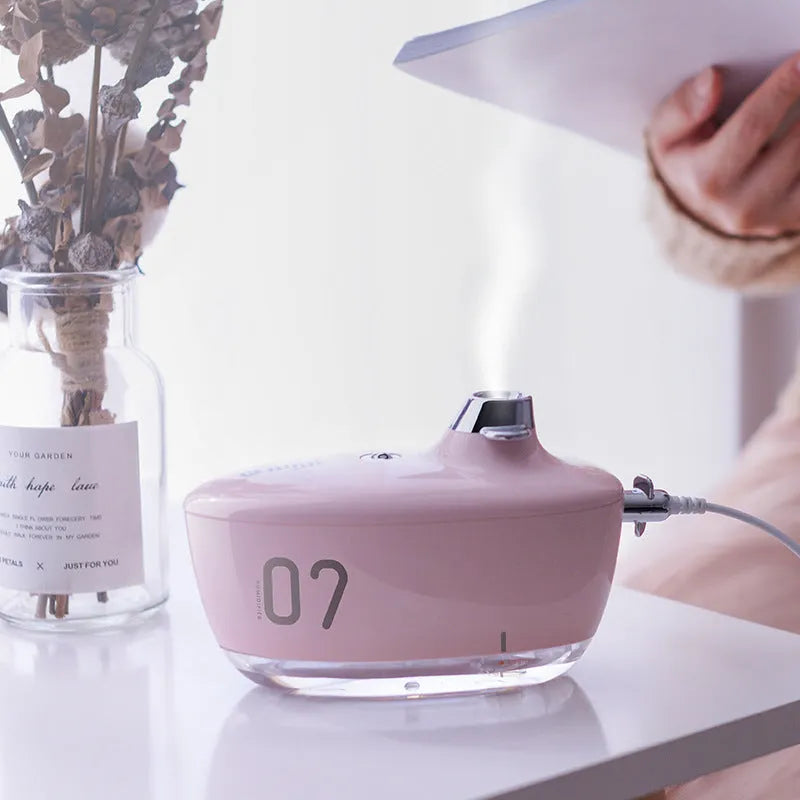 USB small mini portable air purifying humidifier with night light in green, pink, yellow options on desk