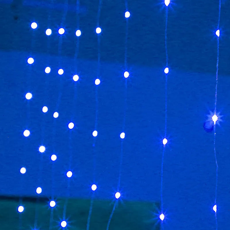 Copper curtain string light with 100 LED bulbs in blue, hung decoratively against a dark background.