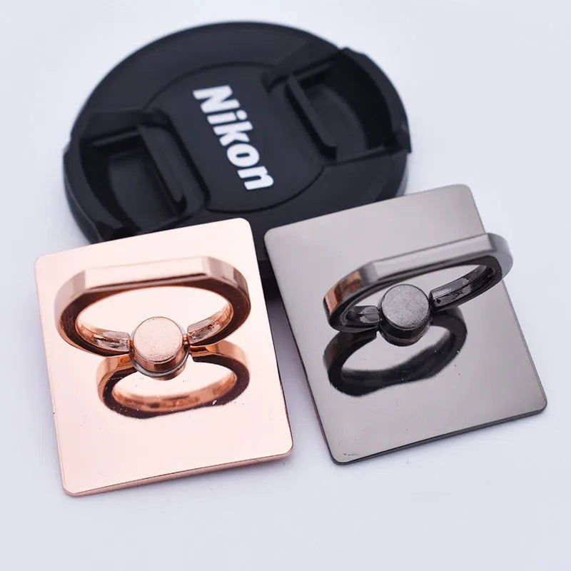 Metal ring phone bracket stand with 360° rotation, black colour, attached to smartphone on desktop