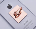 Metal ring phone bracket stand with 360° rotation, black colour, attached to smartphone on desktop