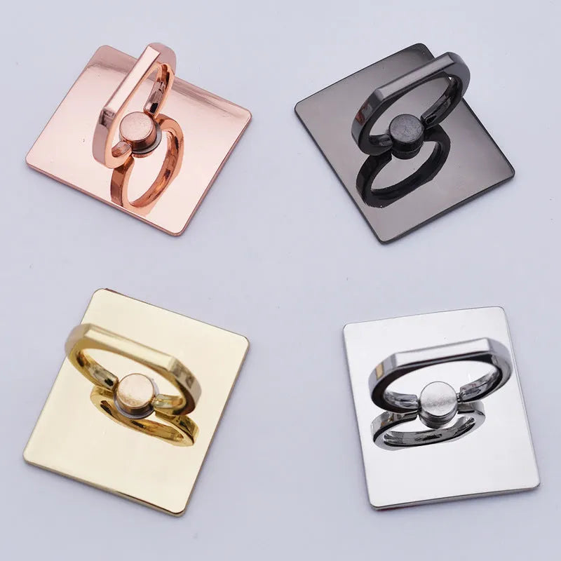 Metal ring phone bracket stand with 360° rotation, black colour, attached to smartphone on desktop