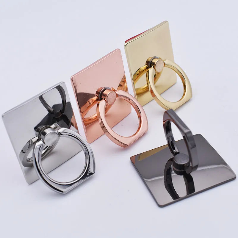 Metal ring phone bracket stand with 360° rotation, black colour, attached to smartphone on desktop