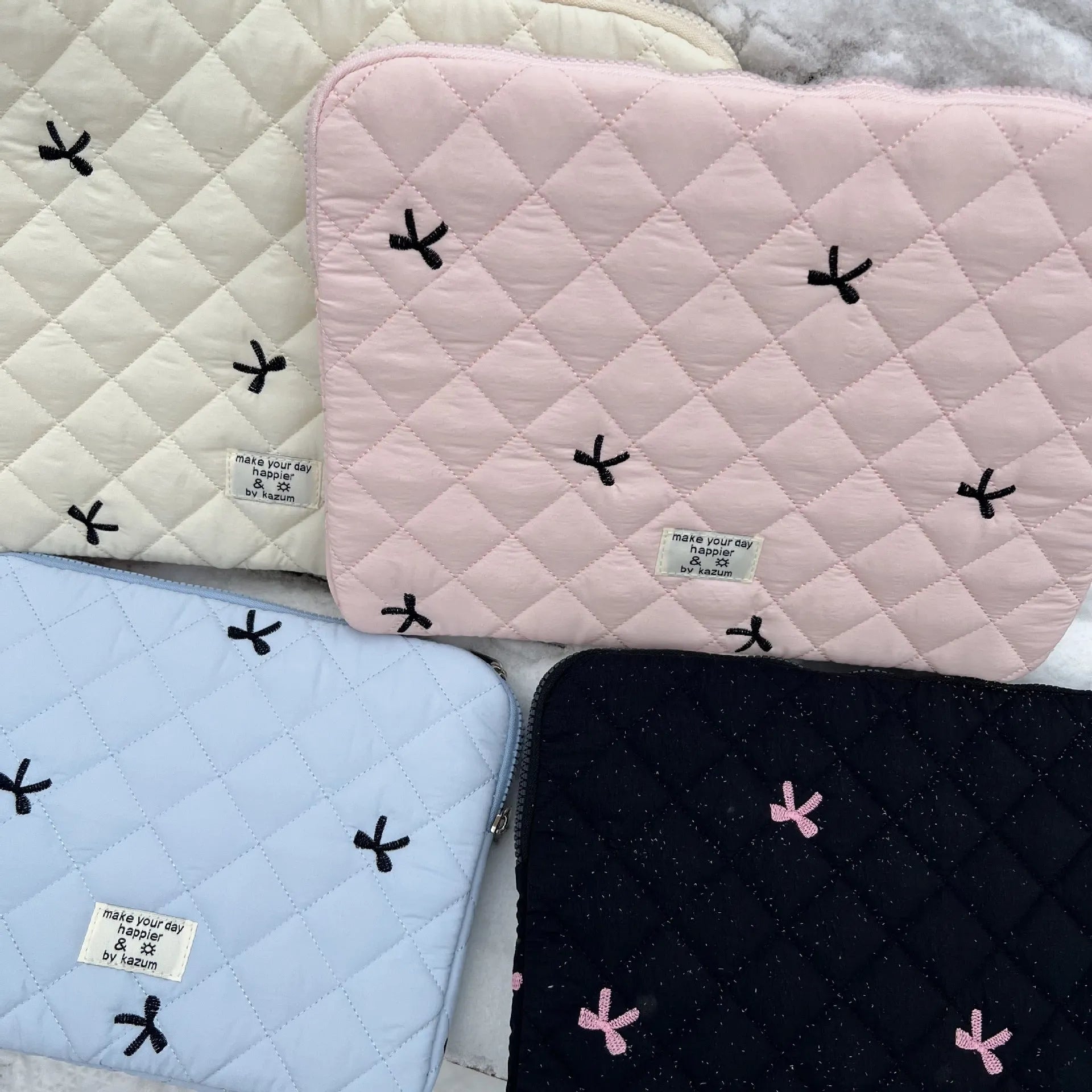 Rhombus embroidered bow design on nylon laptop storage bag showing colour and size options