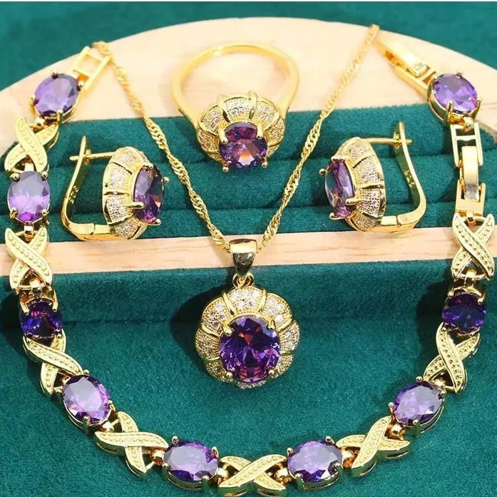 Gold plated zircon jewellery set with necklace, earrings, ring, and bracelet on display.