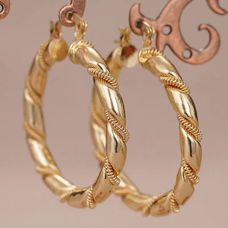 Women's geometric copper earrings with ring and line design elements in golden colours
