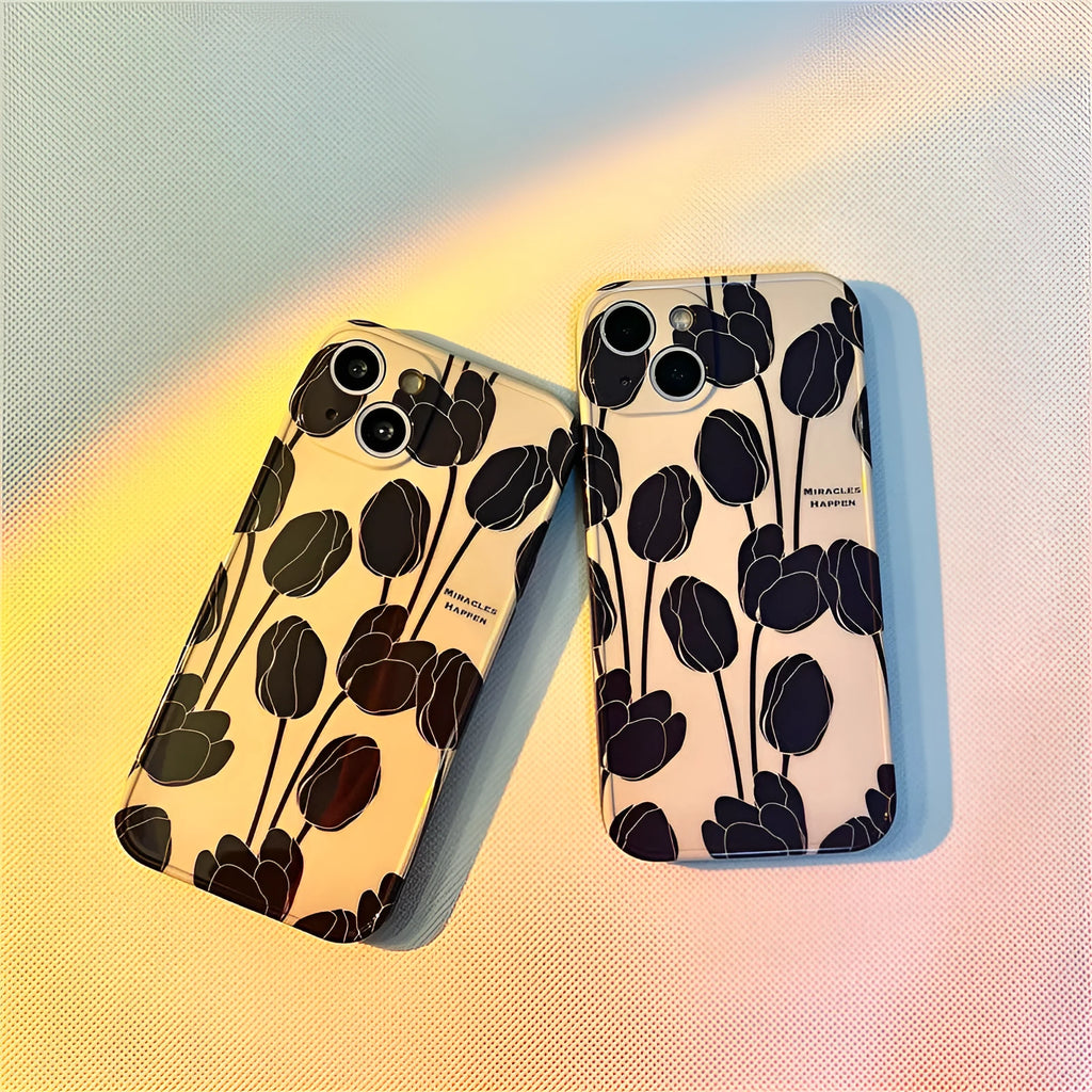 Black silicone iPhone case with a printed white and grey tulip floral design on the back.