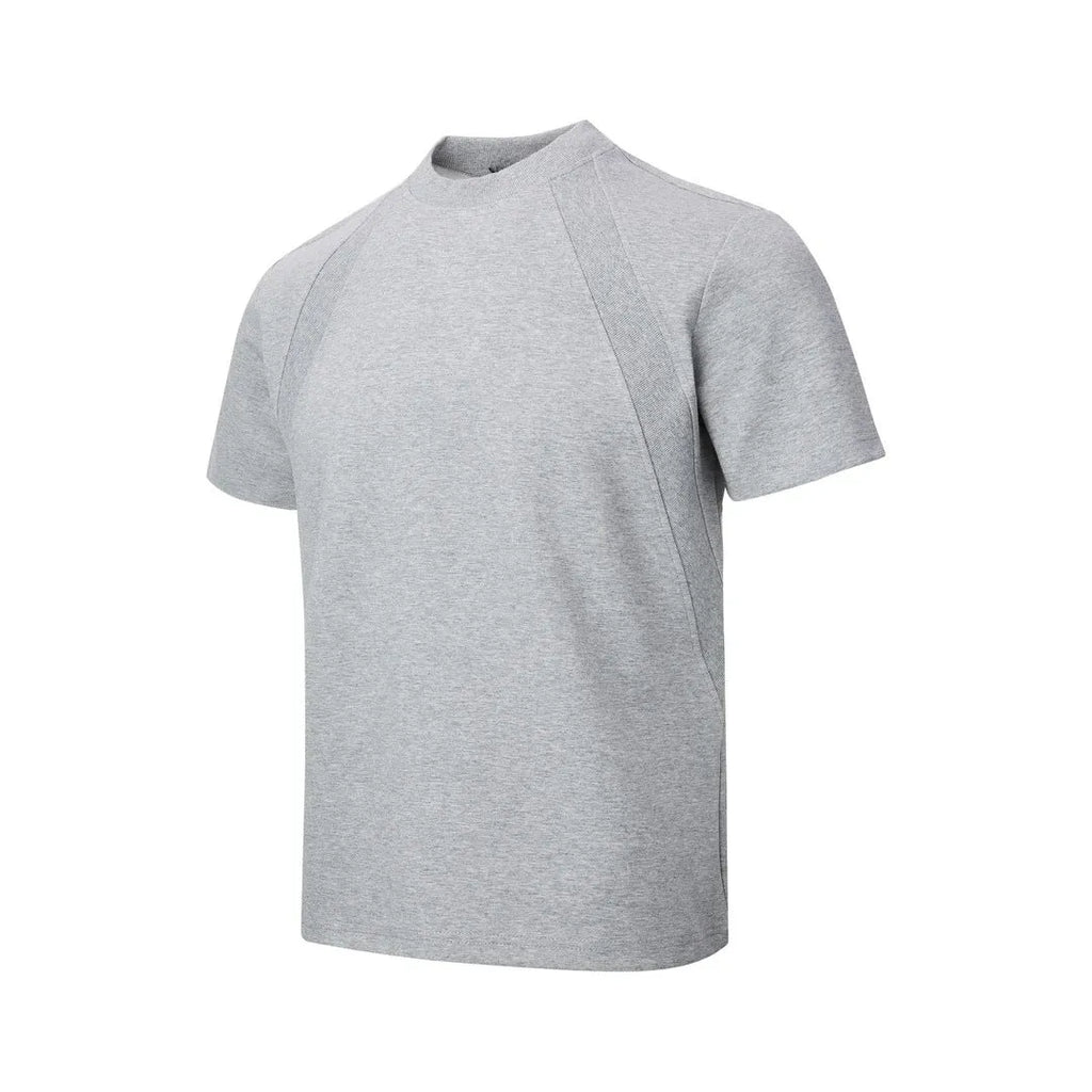 Man wearing a loose fit black short sleeve top with visible air layer stitching detail.