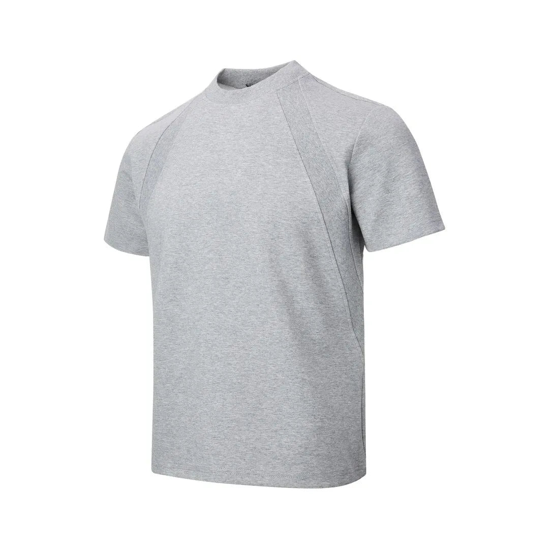 Man wearing a loose fit black short sleeve top with visible air layer stitching detail.