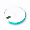 Blue 7-compartment alarm clock pill dispenser showing digital display and separate pill slots.