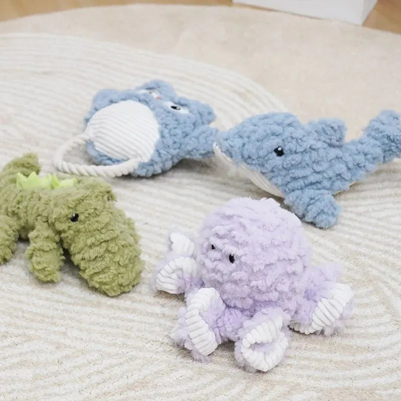 Plush caterpillar fabric dog toy in shark shape with squeaker on white background