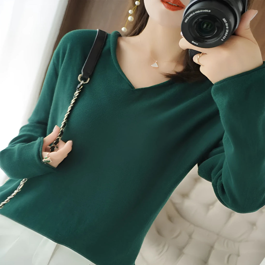 Women's V-neck long sleeve knit top in turmeric colour on a hanger