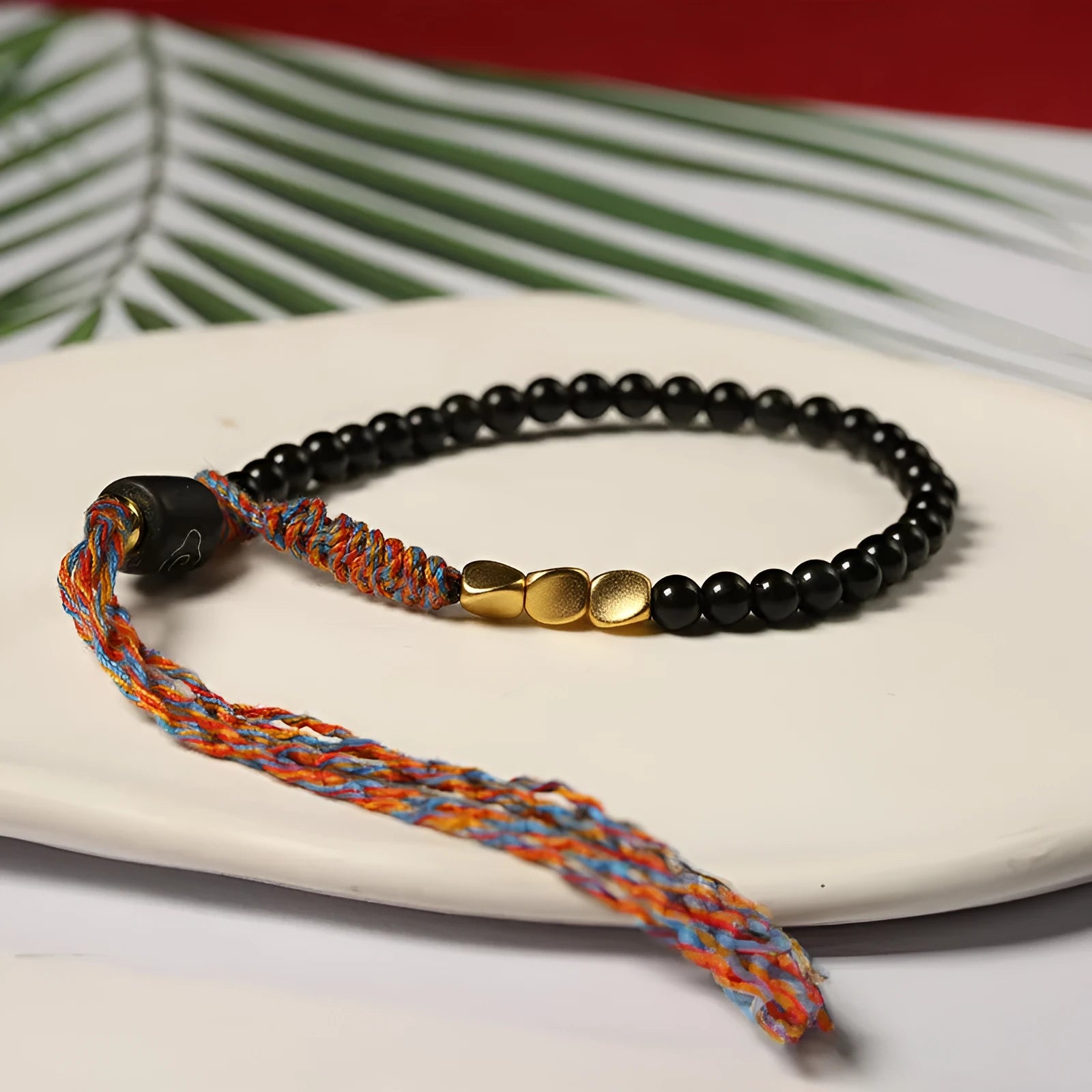 Hand-woven obsidian carrying strap showing 4mm width and textured surface