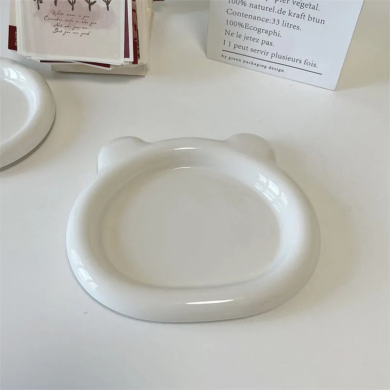White ceramic plate with chubby bear or round toot design, shown in 15cm and 20cm sizes as a plant tray.
