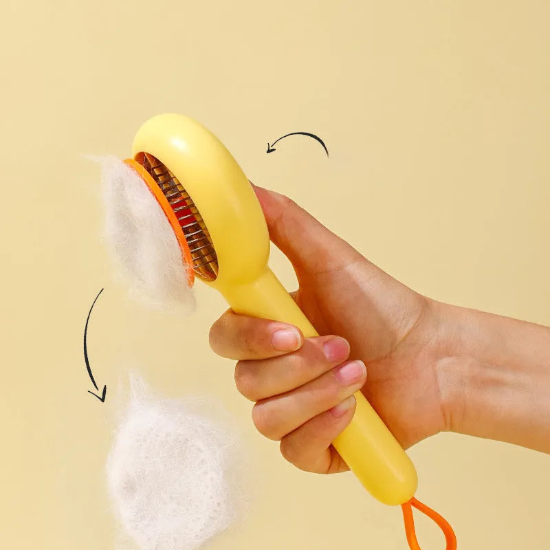 Small plastic pet comb with yellow duck design, showing open sections and floating needles for cat and dog grooming.