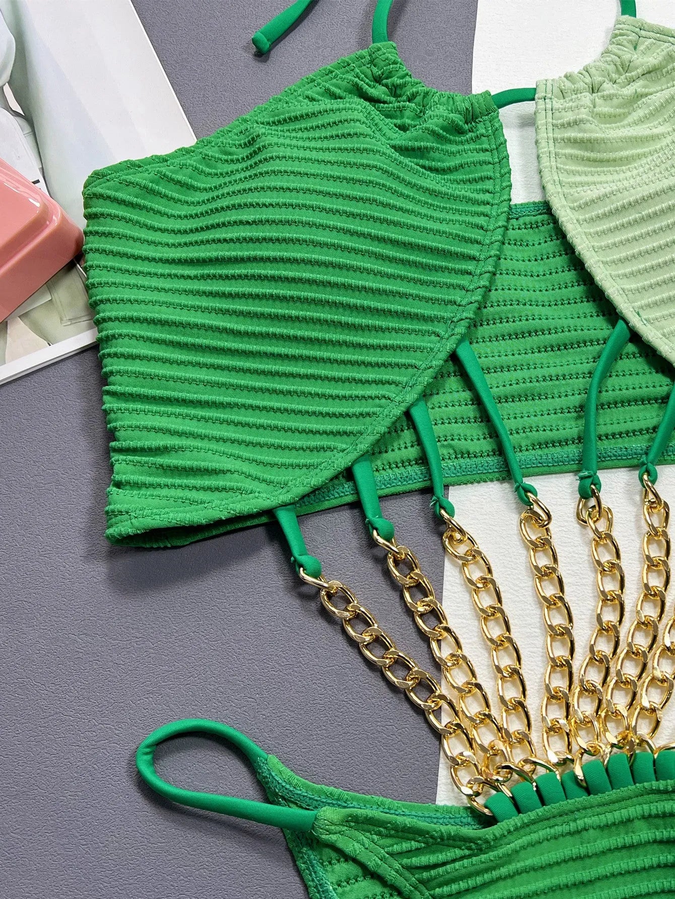 Green women's one-piece swimsuit with hollow design detail in polyester fabric