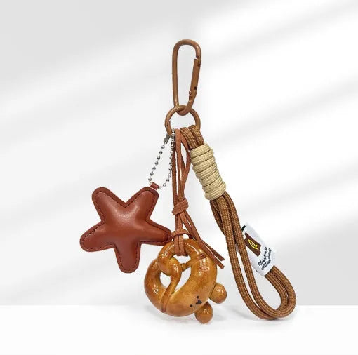 Handmade soda bread handbag pendant with baked varnish finish and brown carrying strap