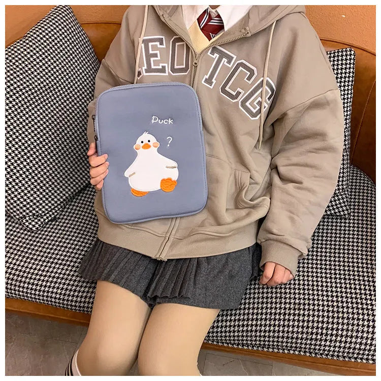 Blue cotton tablet case with embroidered cartoon duck design and zip closure