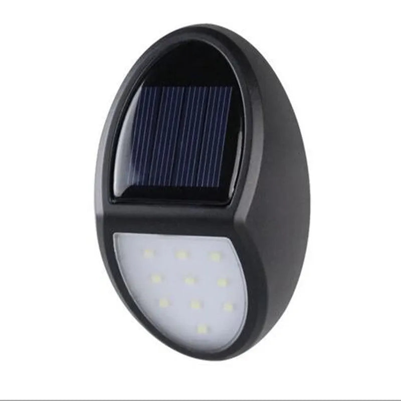 Black rectangular LED solar wall light mounted on an exterior wall for automatic night-time illumination.