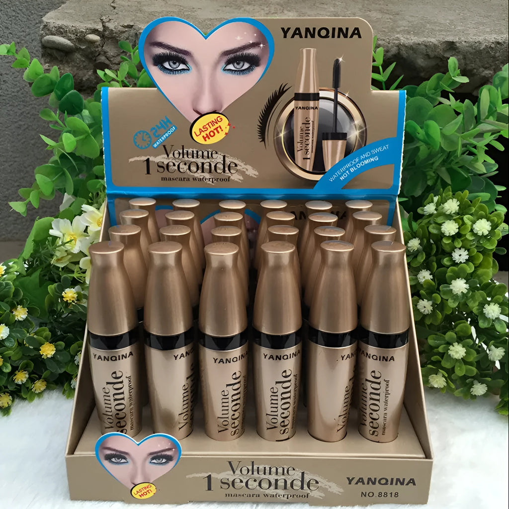 Gold tube black mascara in a vertical orientation against a light background