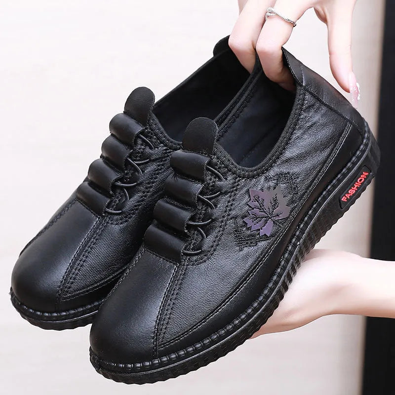 Plus size PU soft bottom slip-on mom shoes in black with leaf pattern, flat heel, and shallow mouth design
