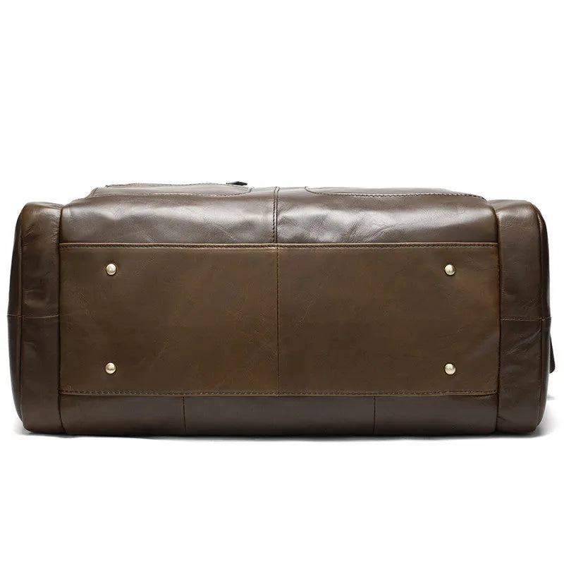 Coffee first layer cowhide leather travel bag with soft handle and zip closure on a plain background