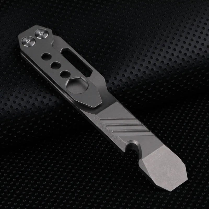 Titanium alloy multi-function crowbar tool with integrated bottle opener in gun grey or stone wash finish.