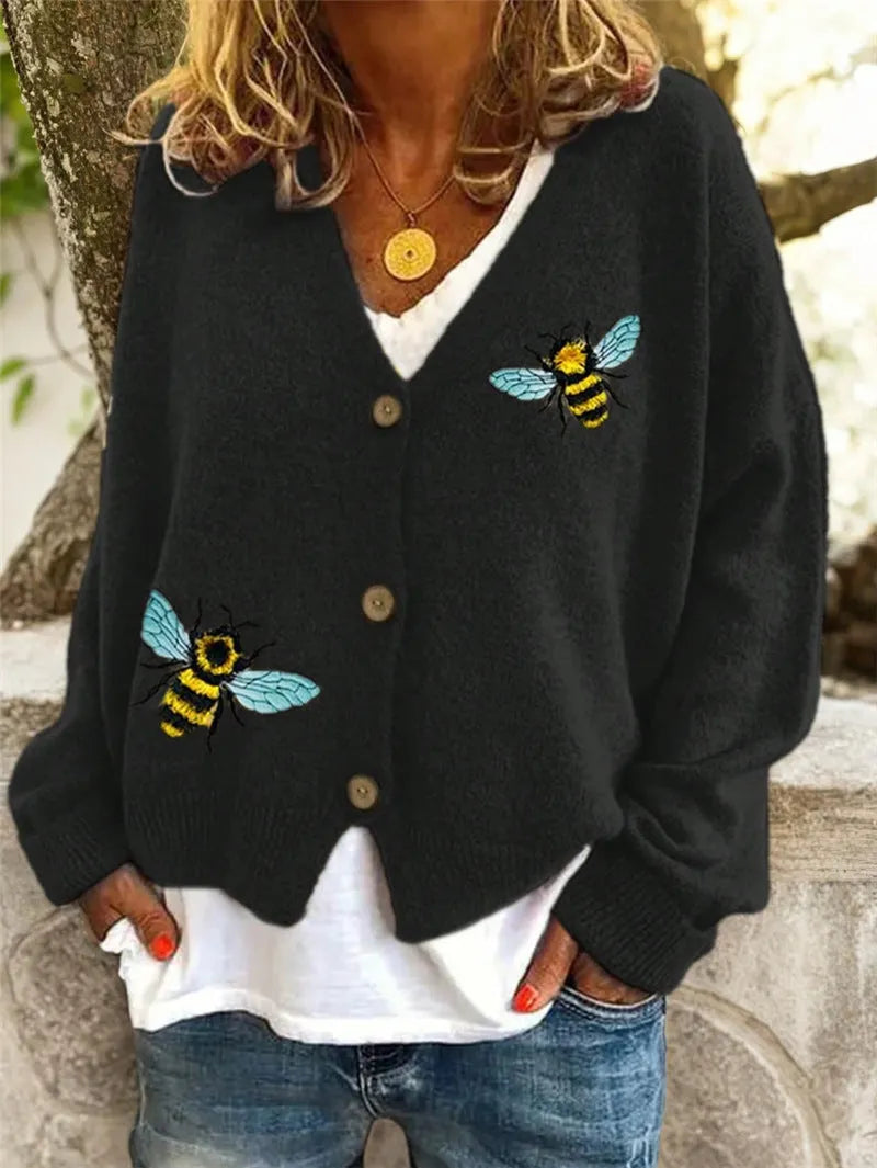 Loose fit animal pattern knitted cardigan sweater in black, made from polyester, with conventional sleeves.