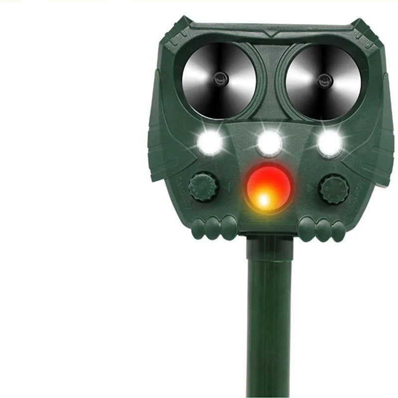 Green solar-powered ultrasonic dog and pest repeller unit for outdoor garden use.