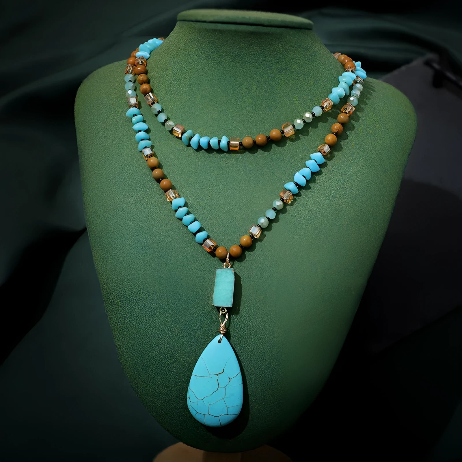 Turquoise blue necklace with water drop shaped pendant on ball bead chain