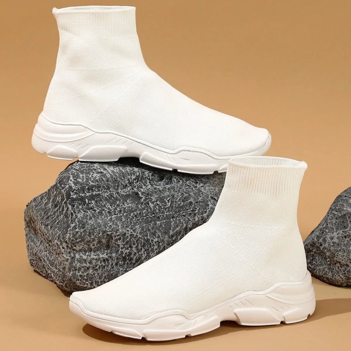 Thick-soled slip-on casual shoes in black with fabric upper, mid-top design, and round toe.