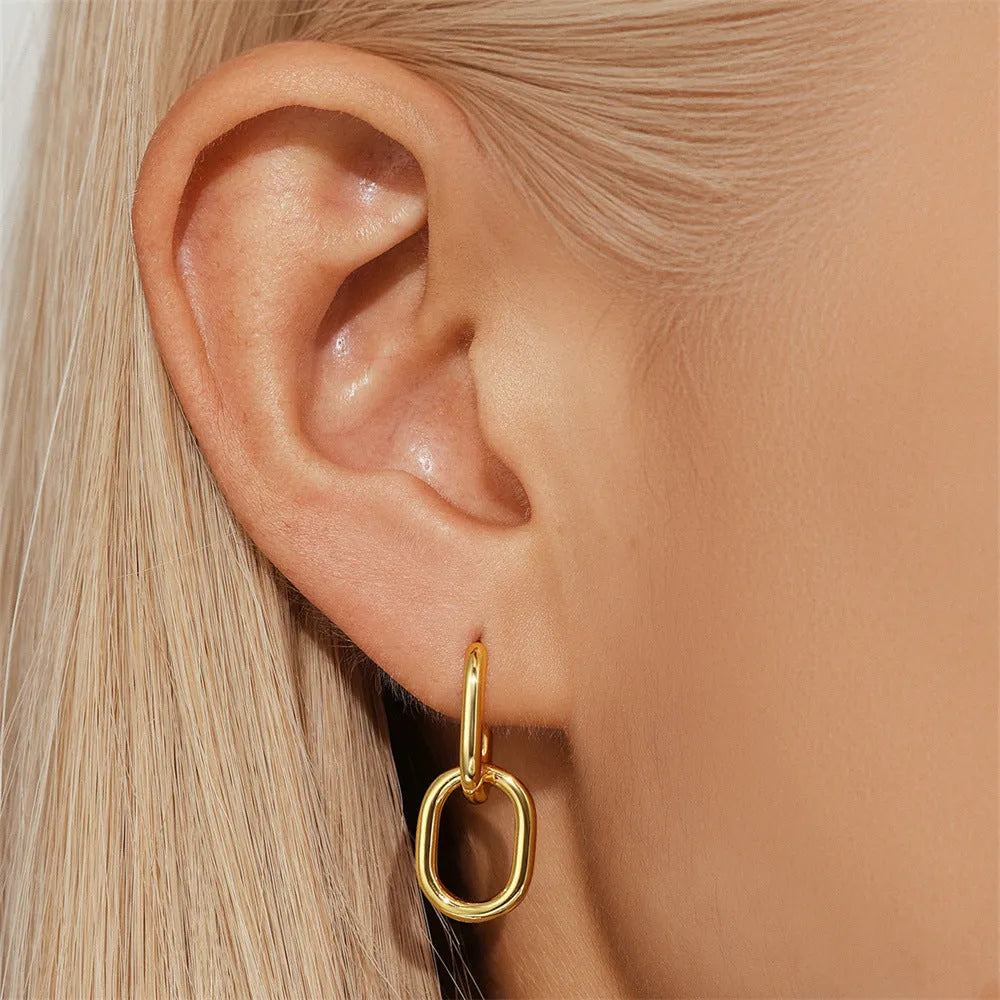 Brass geometric earclip earrings with electroplated gold finish and round design element