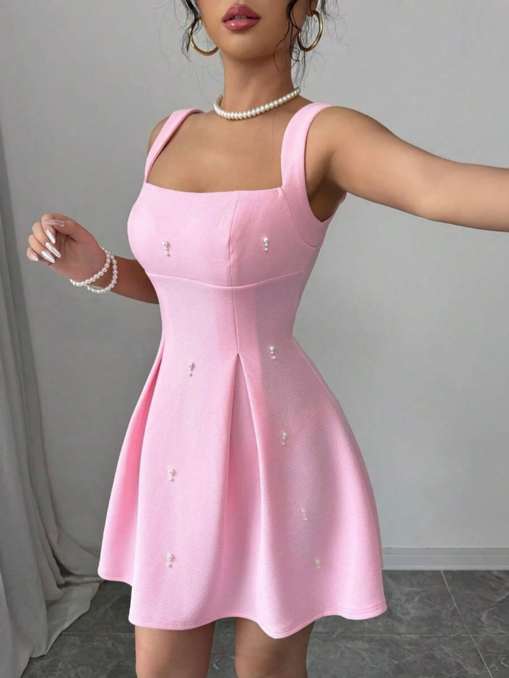 Pink high-waist A-line suspenders dress with short sleeveless skirt in polyester, shown on a model