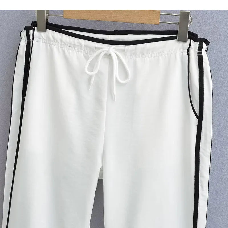 Navy blue and white loose straight leg trousers with ribbon parallel bars detail.