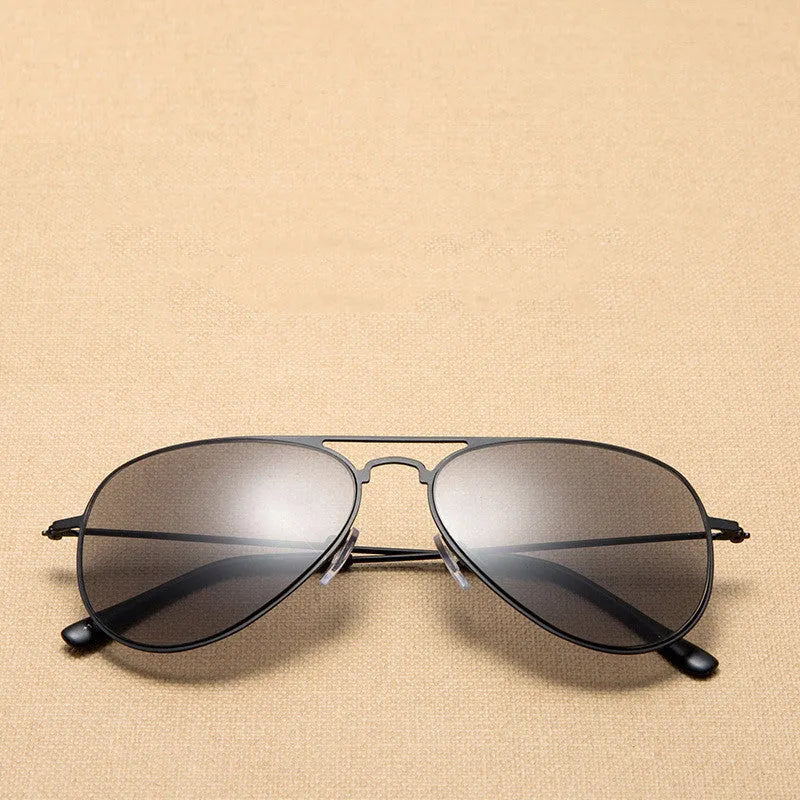 Full lens sun reading glasses with black stainless steel frame resting on a table