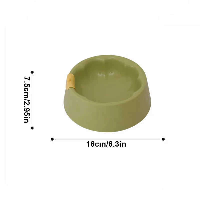 Green plastic double pet bowl with flower-shaped feeding areas and anti-tipping base design