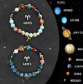Two natural stone beaded bracelets representing zodiac signs on a wrist.