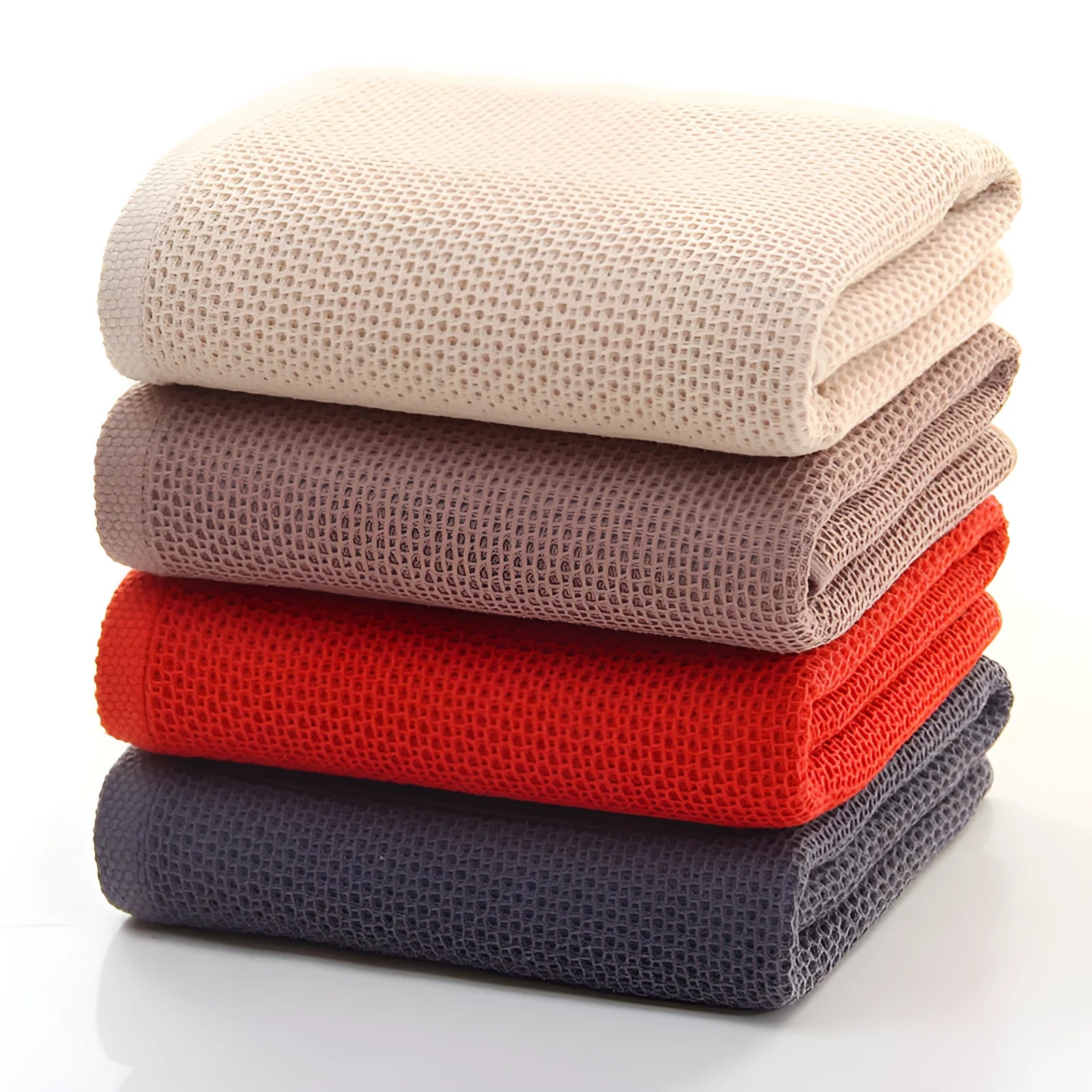 All-cotton jacquard bath towel in beige, 70x140cm, folded on a bathroom shelf