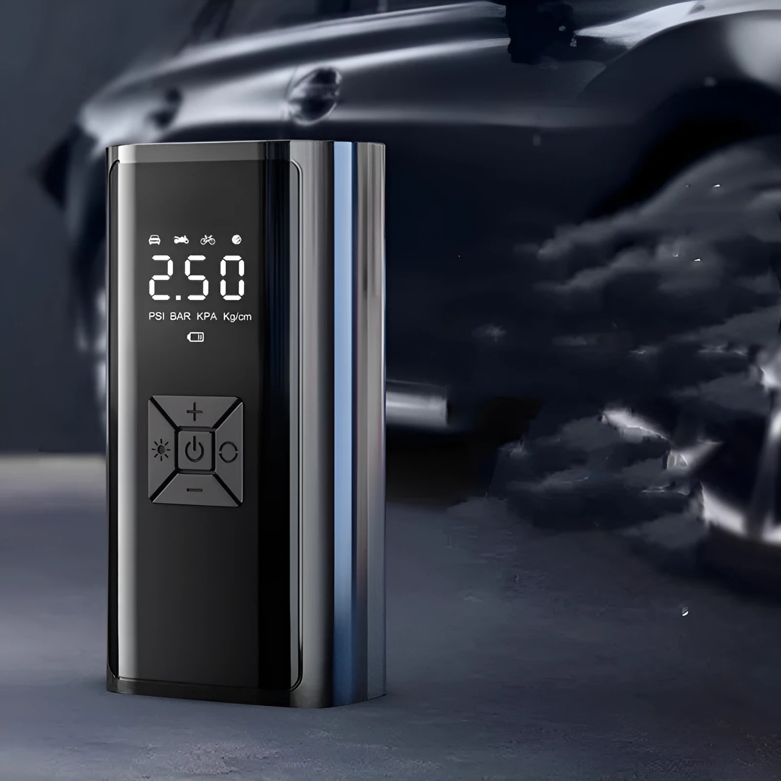 Portable wireless digital car tyre pump with display, hose, and cables on a grey background.