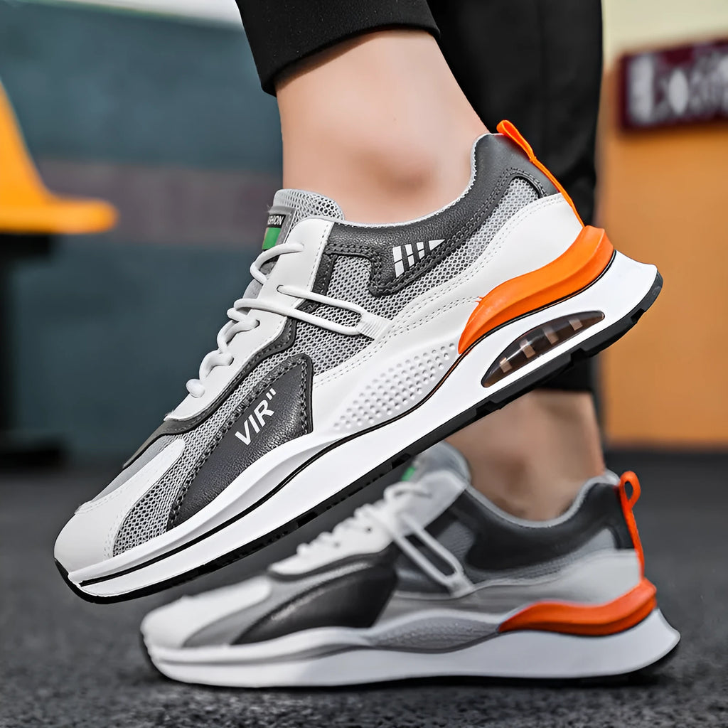 Men's grey and black mesh running shoes with round toe and mid-top design on white background