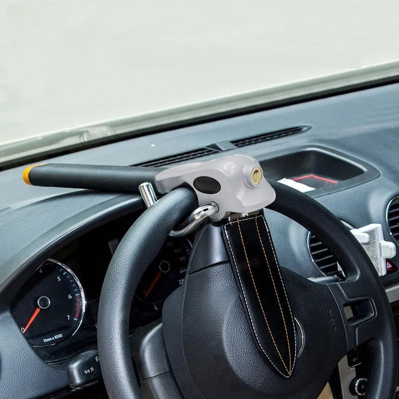 Universal car steering wheel lock with alarm in black gold finish on vehicle steering wheel