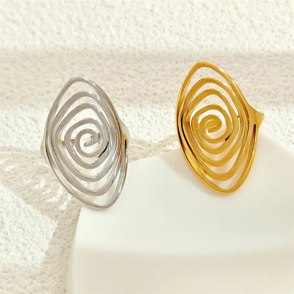 Stainless steel exaggerated circle geometric ring in gold colour, adjustable opening, front view.