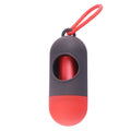 Compact black dog poop bag holder with a metal hook and Velcro strap, showing scale.