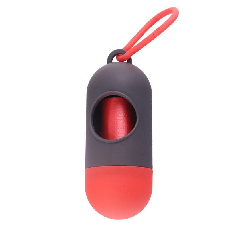 Compact black dog poop bag holder with a metal hook and Velcro strap, showing scale.
